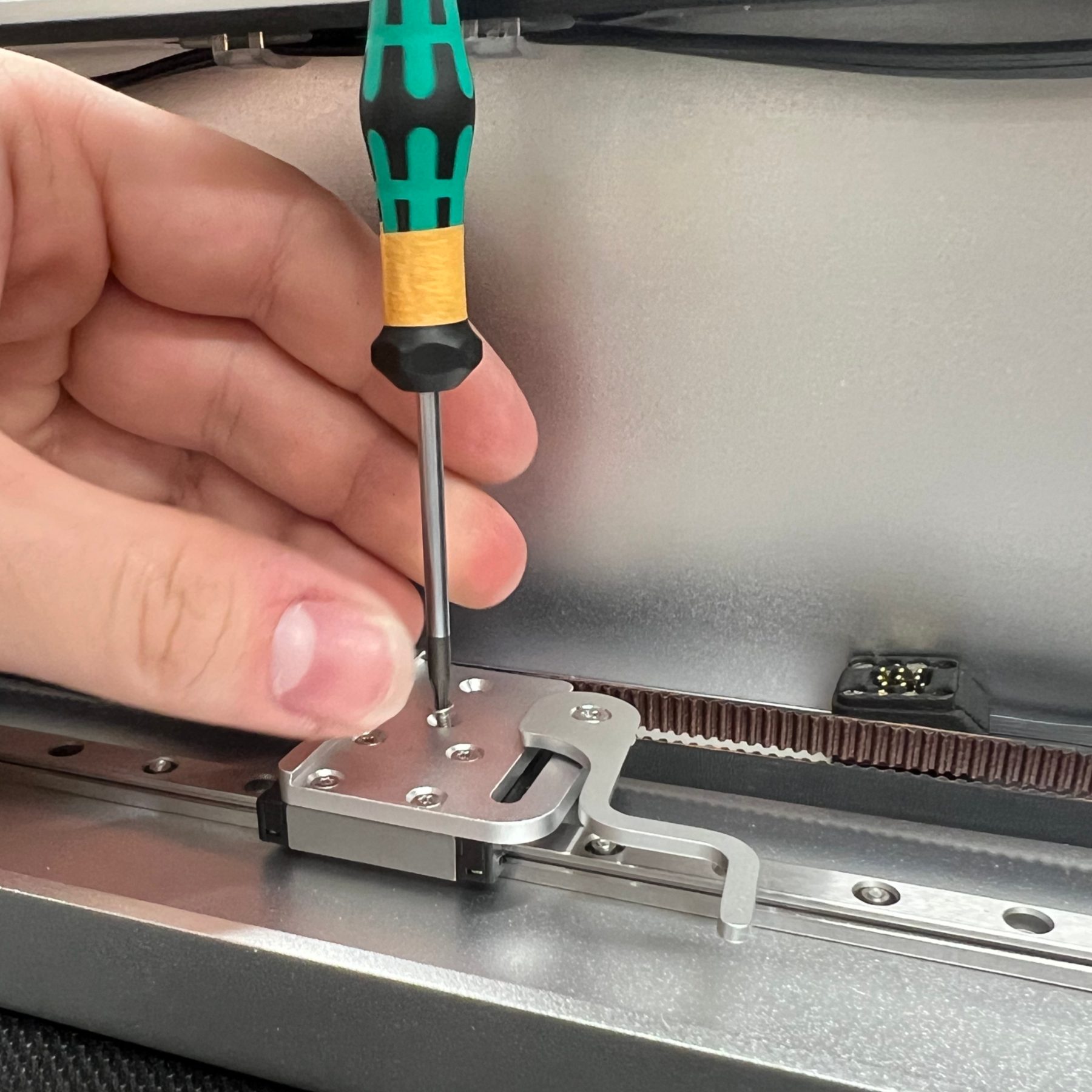 Bolting the laser module carriage to the linear rail.