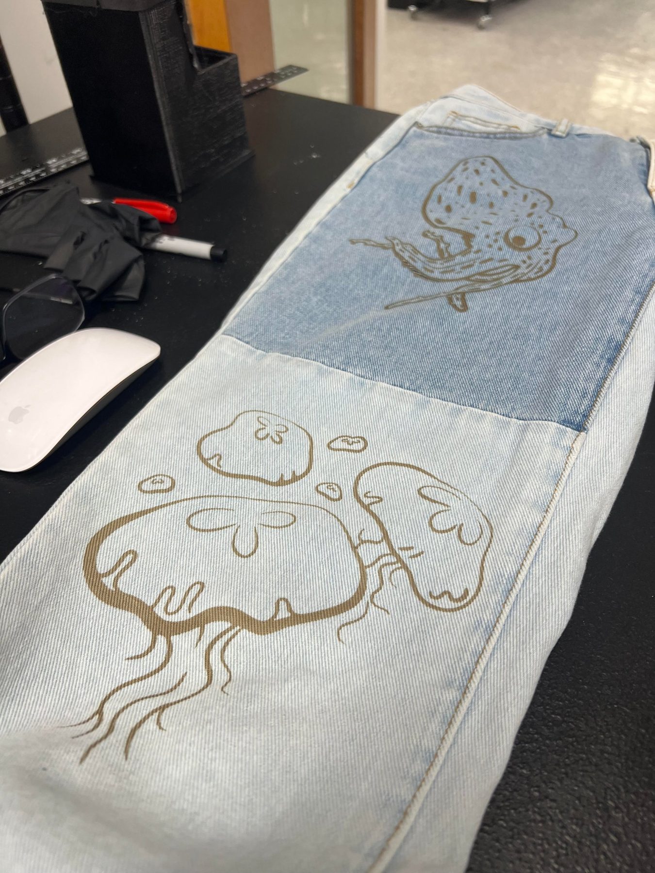 Jellyfish and squid designs engraved on denim