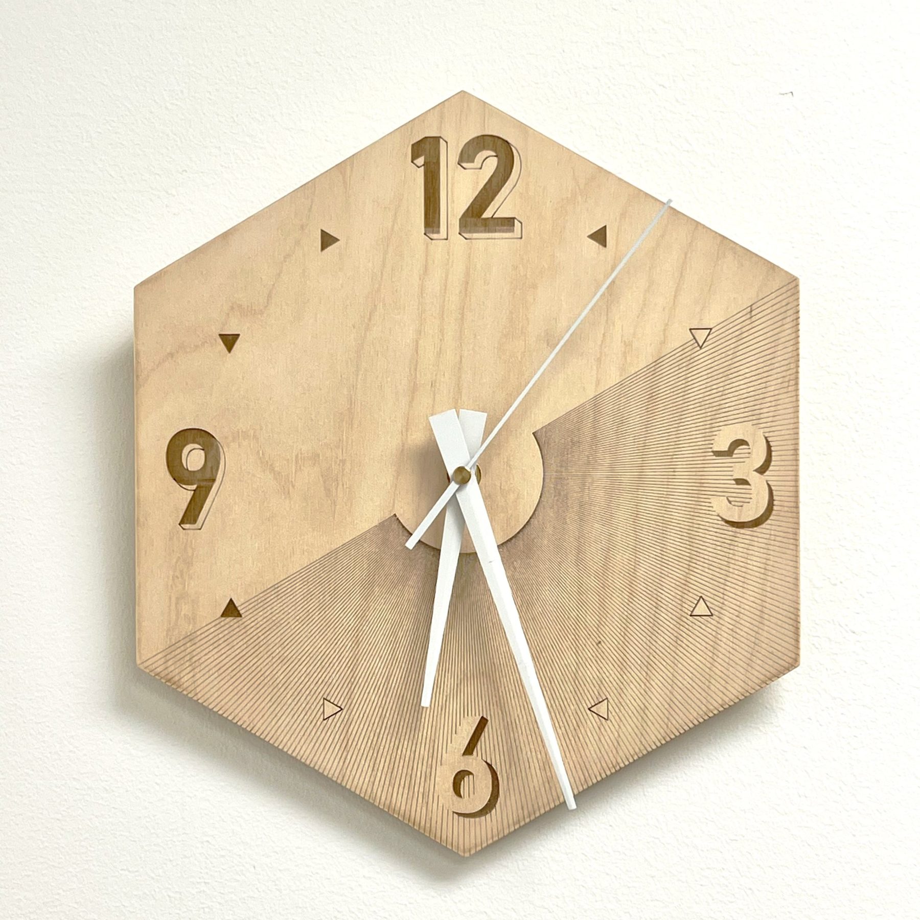 Hexagonal wooden wall clock with engraved numerals